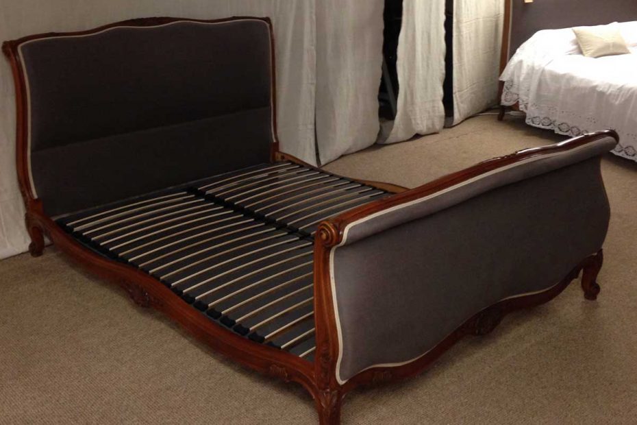 Metal and beech slatted bed base shown on a scroll end original French bed